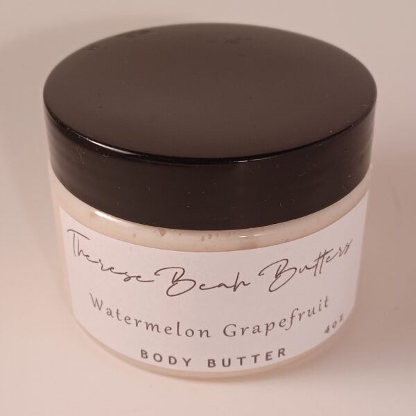 Clear jar with black lid. ThereseBeah Butters logo in fancy script. Watermelon Grapefruit Shea butter written in script detailing fragrance. 4 ounce product content. Butter is an ivory color.