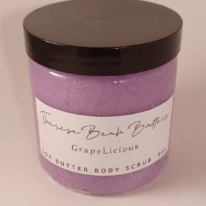 Clear jar with black lid. ThereseBeah Butters logo in fancy script. GrapeLicious soy butter scrub detailing fragrance written in script detailing 8 ounce product content. Scrub is a purple color.